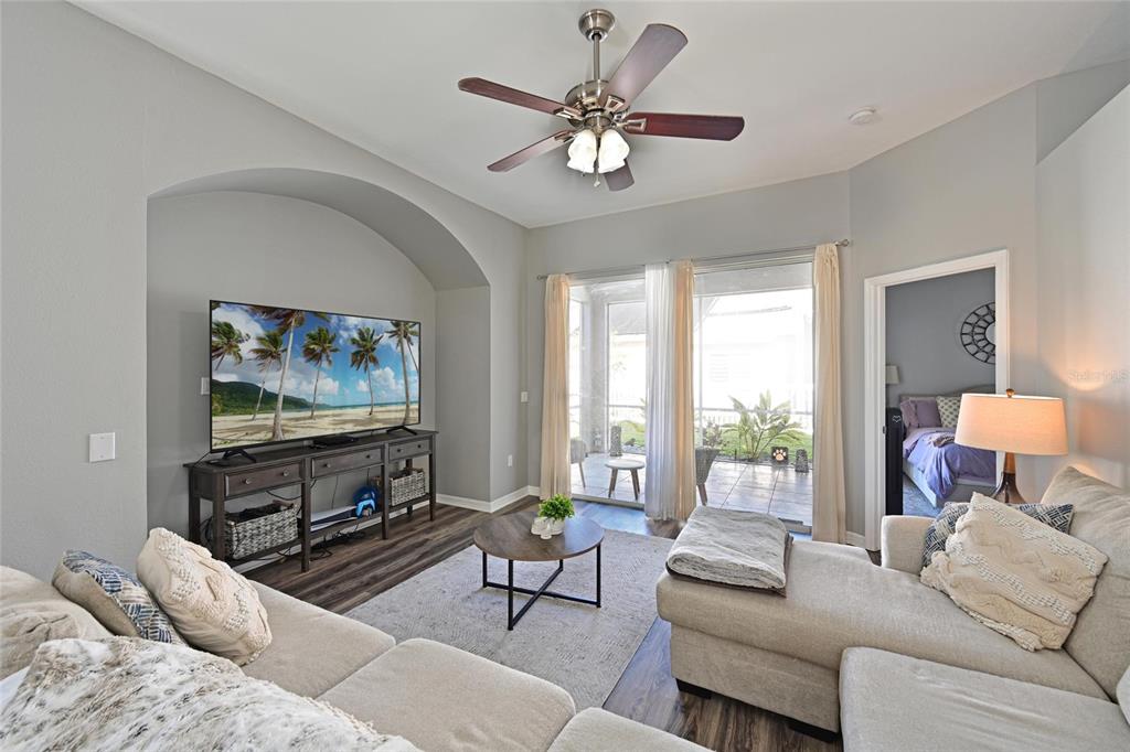 12709 Nightshade Place Lakewood Ranch, FL 34202 - Photo 15 of 53 a living room with furniture a large window and a flat screen tv