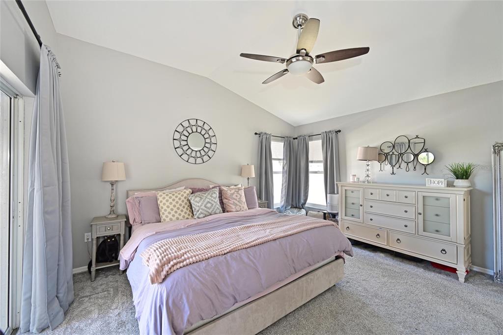 12709 Nightshade Place Lakewood Ranch, FL 34202 - Photo 27 of 53 a bedroom with a bed and a chandelier