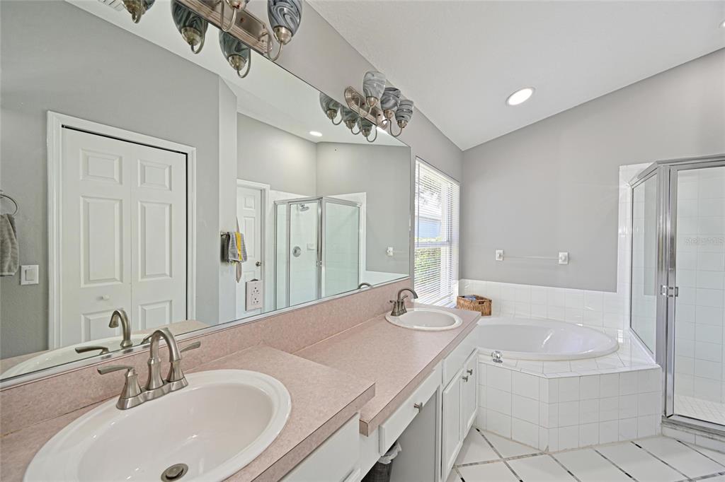 12709 Nightshade Place Lakewood Ranch, FL 34202 - Photo 28 of 53 a bathroom with a granite countertop sink a large mirror and bathtub
