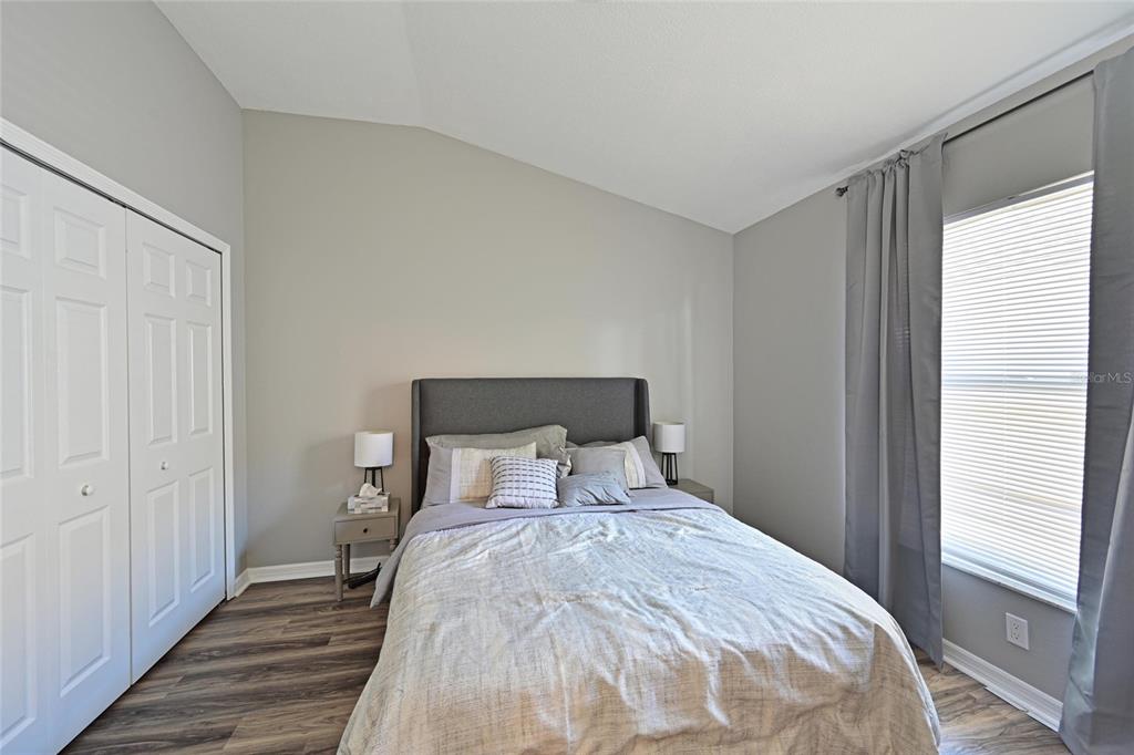 12709 Nightshade Place Lakewood Ranch, FL 34202 - Photo 31 of 53 a bedroom with a bed and wooden floor