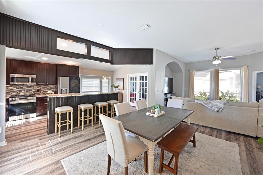 12709 Nightshade Place Lakewood Ranch, FL 34202 - Photo 6 of 53 a view of a dining room with furniture