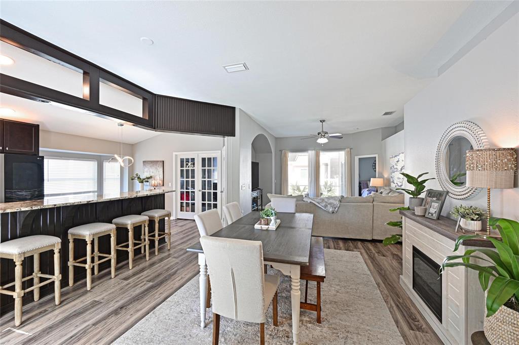 12709 Nightshade Place Lakewood Ranch, FL 34202 - Photo 7 of 53 a view of a dining room with furniture a rug and wooden floor