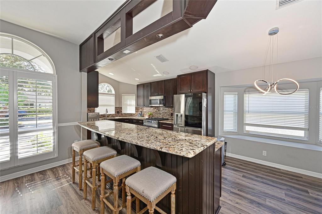 12709 Nightshade Place Lakewood Ranch, FL 34202 - Photo 10 of 53 a dining room with furniture and wooden floor