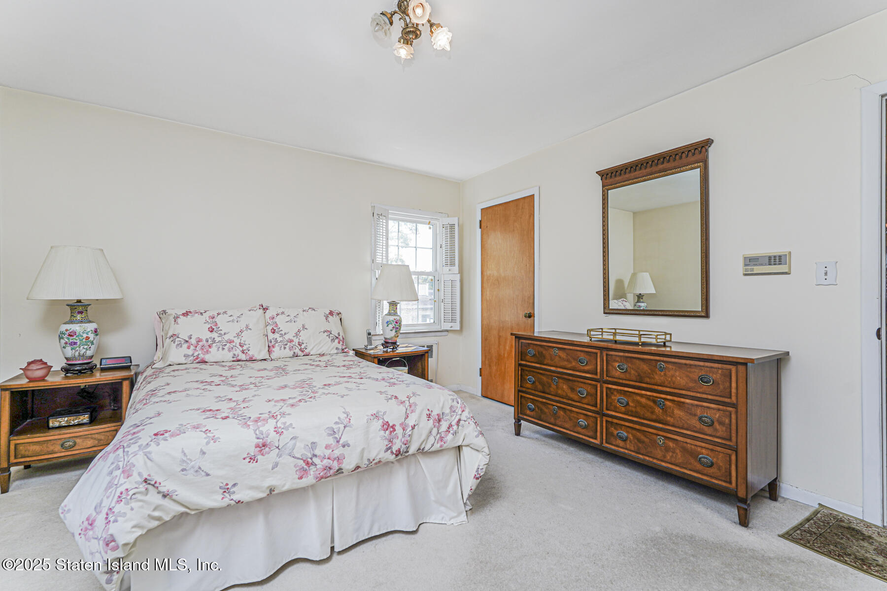 112 Windermere Road Staten Island, NY 10305 - Photo 11 of 32 a bedroom with a bed and a dresser in it