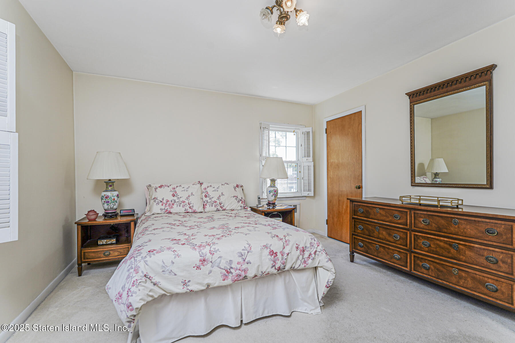 112 Windermere Road Staten Island, NY 10305 - Photo 12 of 32 a bedroom with a bed and a dresser