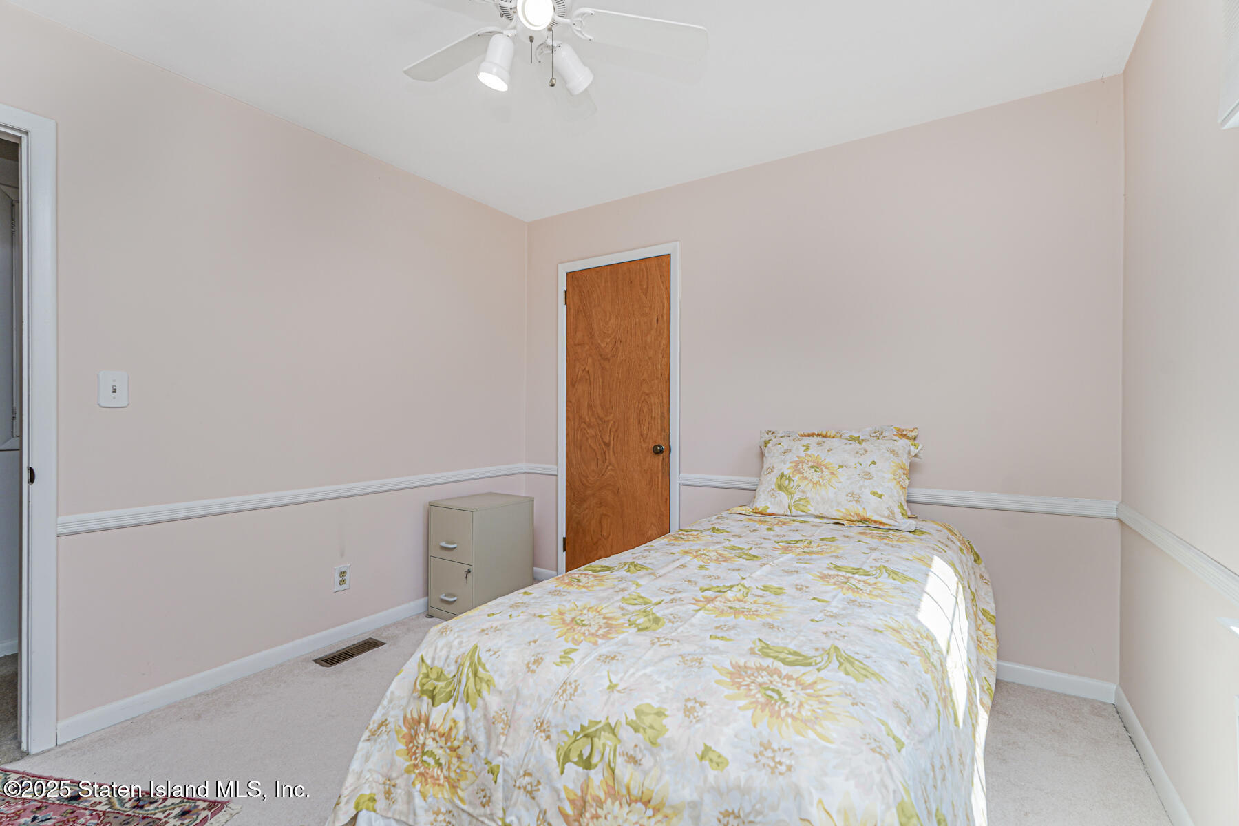 112 Windermere Road Staten Island, NY 10305 - Photo 14 of 32 a bedroom with a bed and a chandelier
