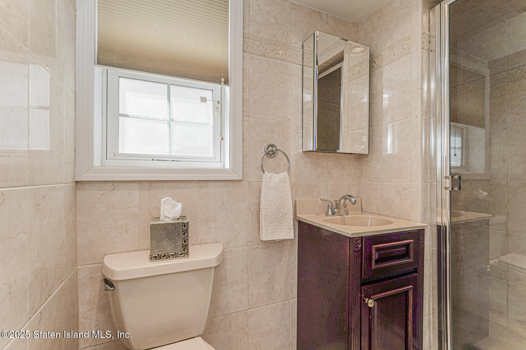 112 Windermere Road Staten Island, NY 10305 - Photo 18 of 32 a bathroom with a toilet sink and mirror