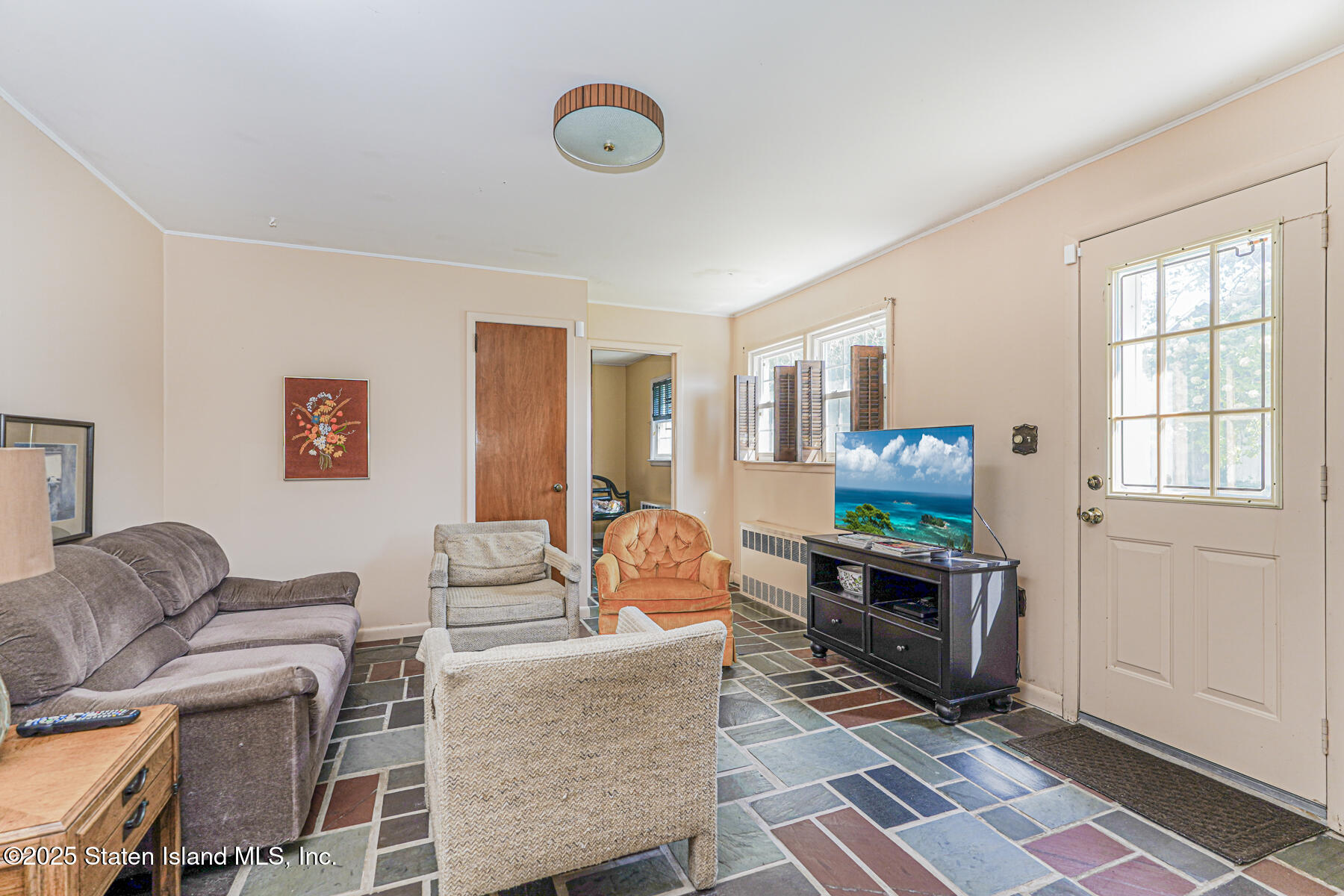 112 Windermere Road Staten Island, NY 10305 - Photo 20 of 32 a living room with furniture a flat screen tv and a window