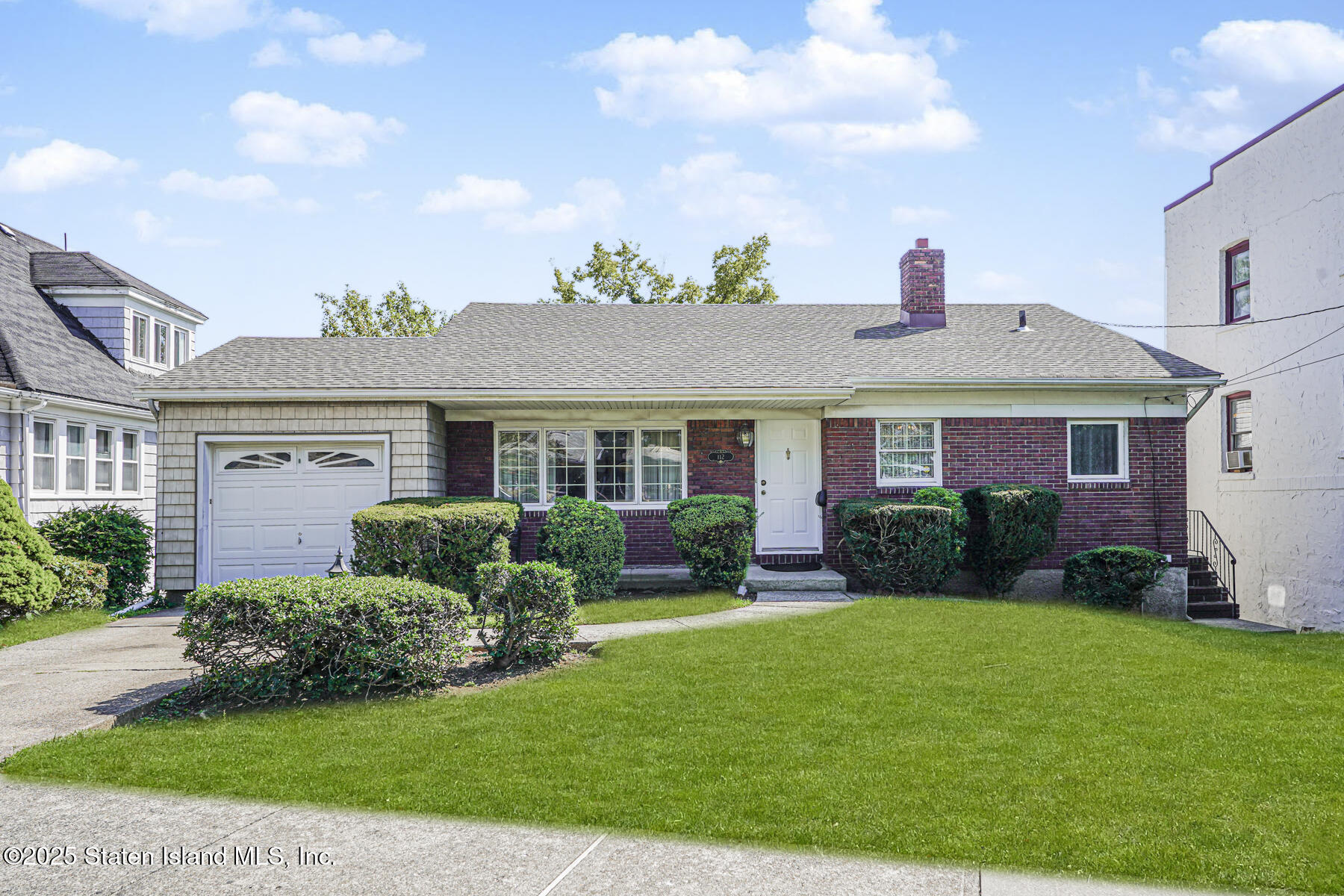 112 Windermere Road Staten Island, NY 10305 - Photo 2 of 32 a front view of a house with a yard