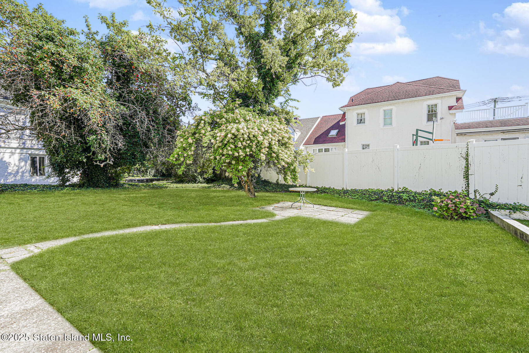 112 Windermere Road Staten Island, NY 10305 - Photo 23 of 32 a view of a white house with a yard and potted plants
