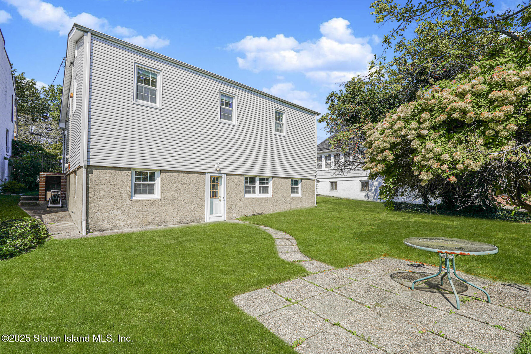 112 Windermere Road Staten Island, NY 10305 - Photo 24 of 32 a view of a house with a yard and sitting area