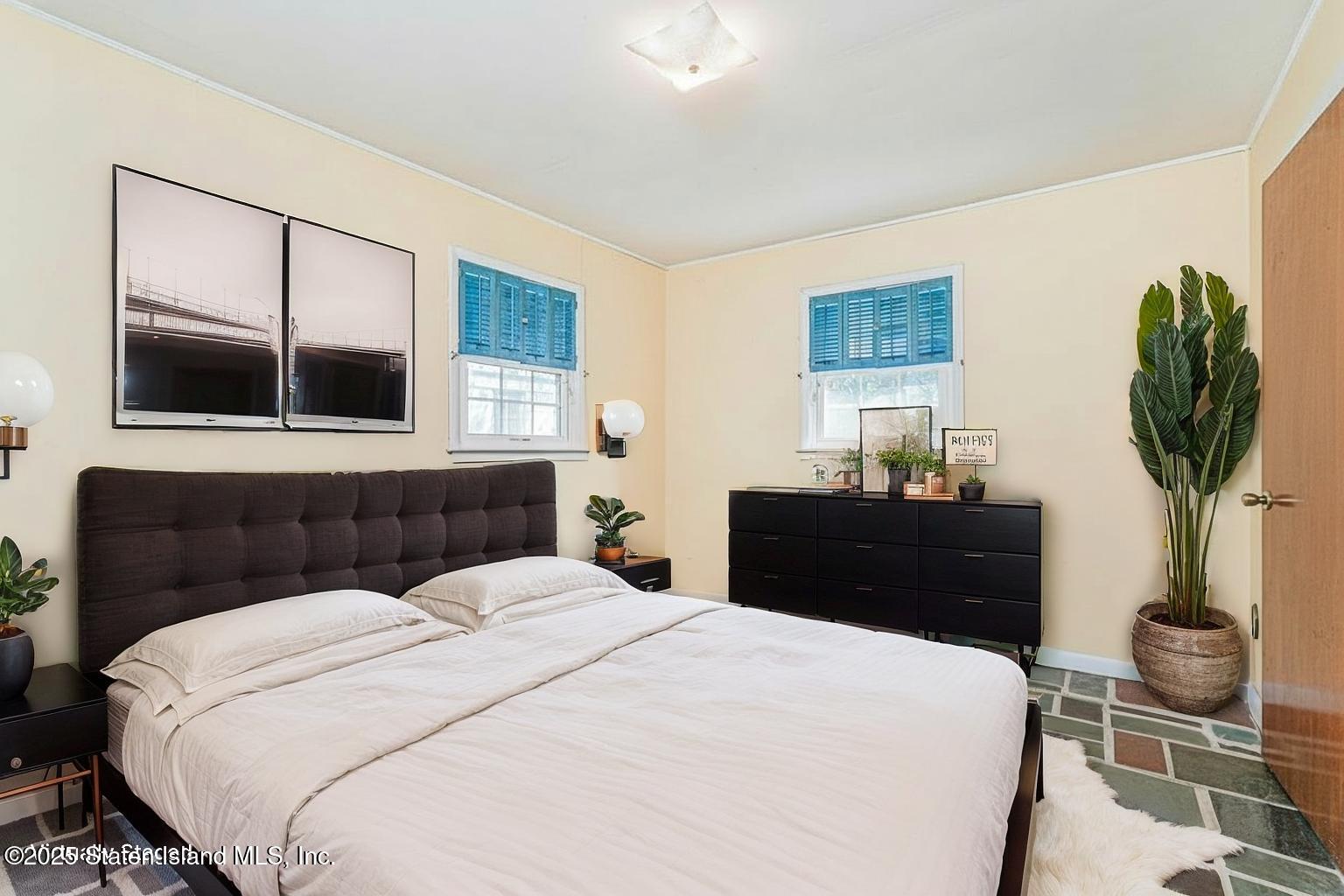 112 Windermere Road Staten Island, NY 10305 - Photo 27 of 32 a bedroom with a bed and a potted plant