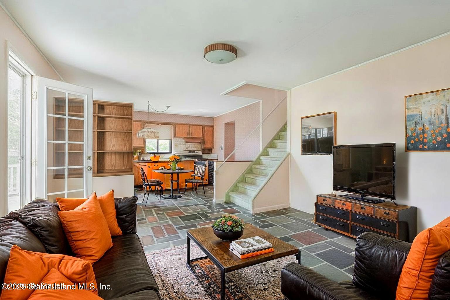 112 Windermere Road Staten Island, NY 10305 - Photo 28 of 32 a living room with furniture and a flat screen tv