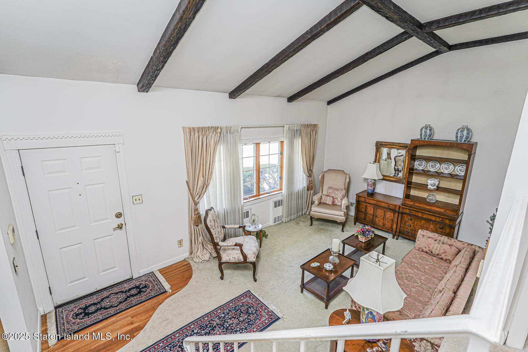 112 Windermere Road Staten Island, NY 10305 - Photo 5 of 32 a living room with furniture a rug and a window