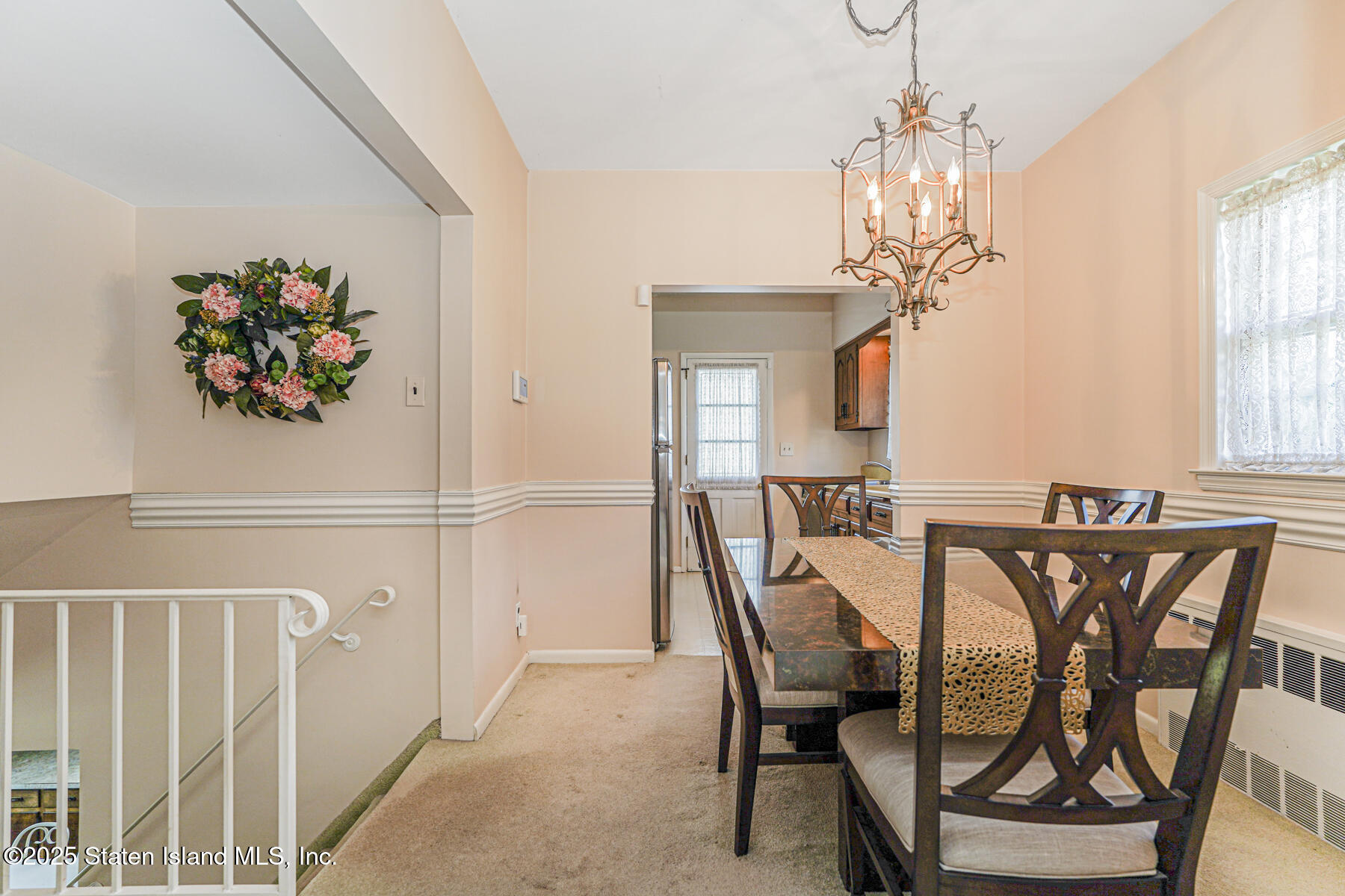 112 Windermere Road Staten Island, NY 10305 - Photo 7 of 32 a view of a dining room with furniture and a chandelier