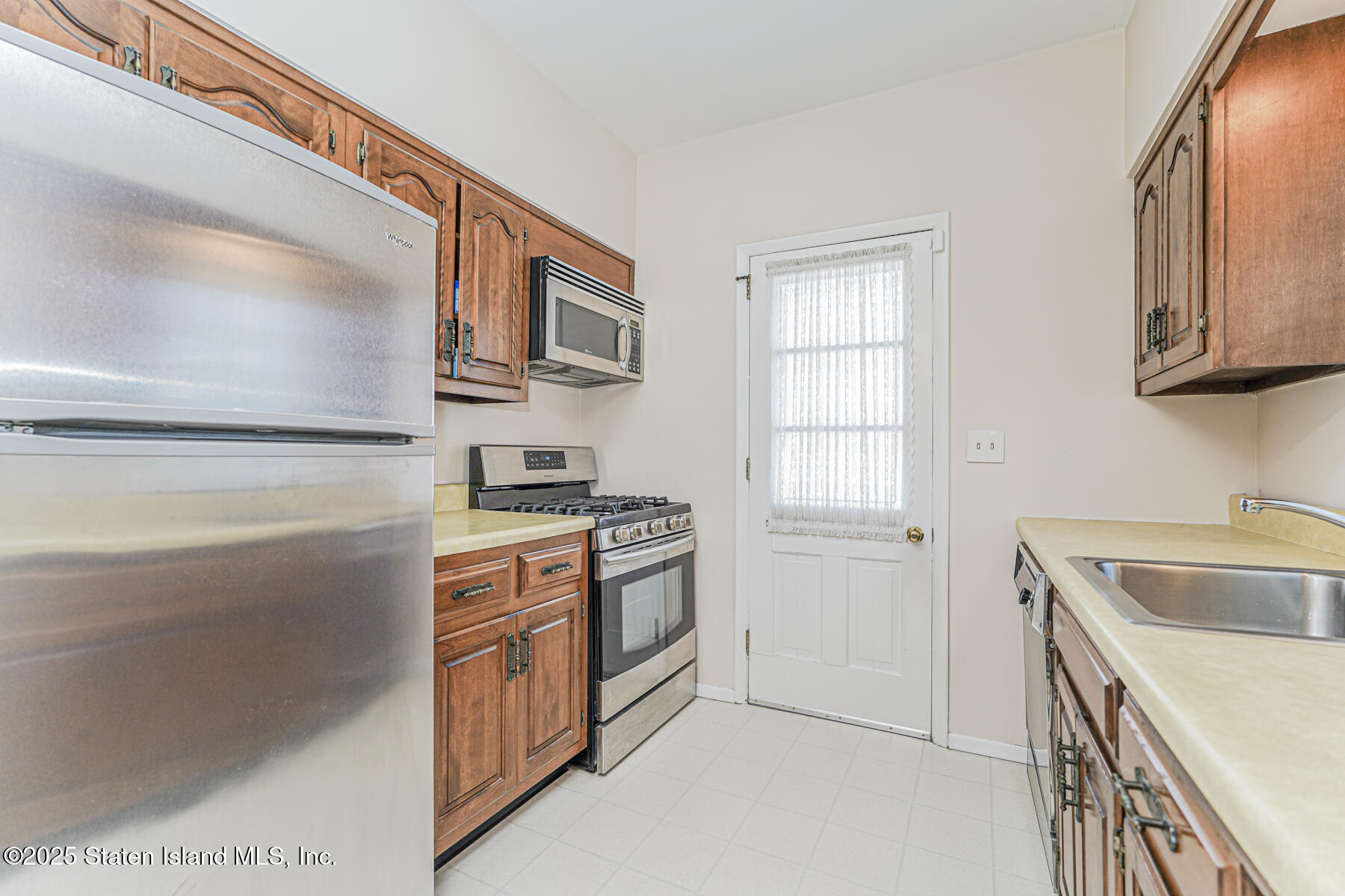 112 Windermere Road Staten Island, NY 10305 - Photo 9 of 32 a kitchen with stainless steel appliances granite countertop a sink and a stove top oven