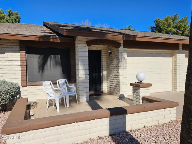 a view of a patio with table and chairs with wooden floor and fence