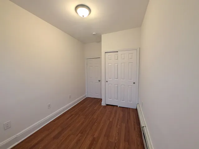 a view of a room with wooden floor