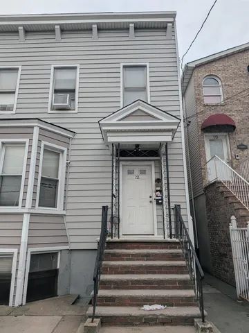 a view of a house with a door and stairs