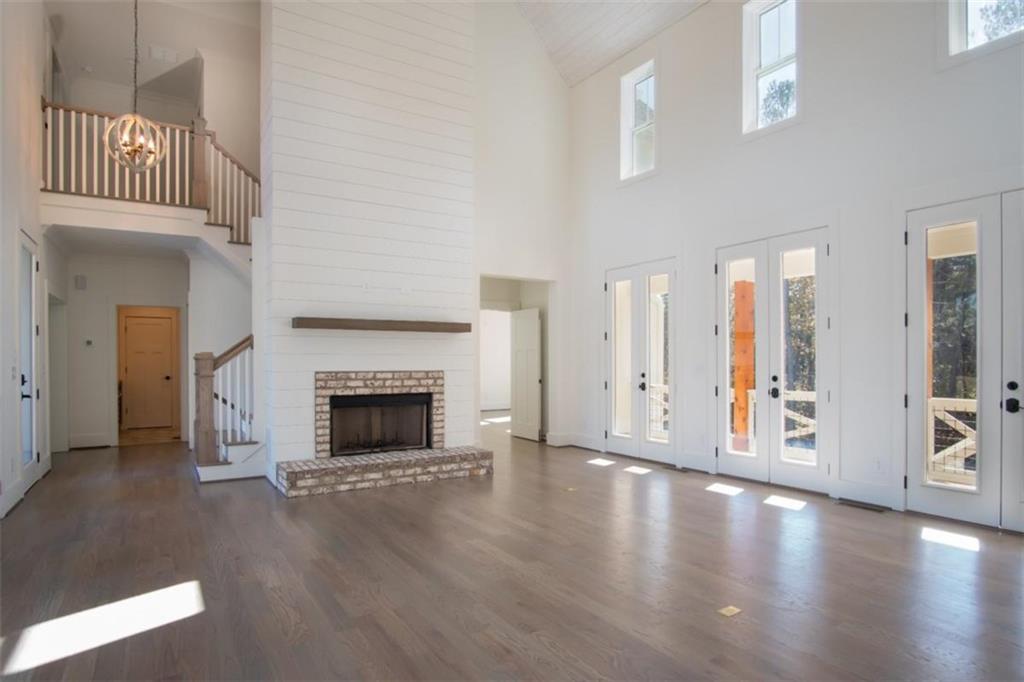 Lot 4 Cox Road Woodstock, GA 30188 - Photo 26 of 37 a view of a big room with wooden floor fire place and windows