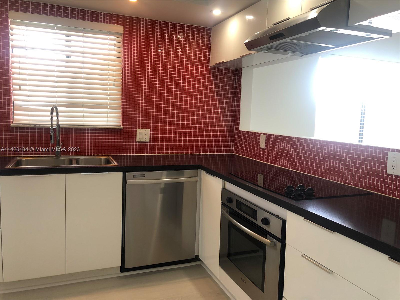 330 Racquet Club Road, Unit 201 Weston, FL 33326 - Photo 11 of 43 a kitchen with a sink and a microwave
