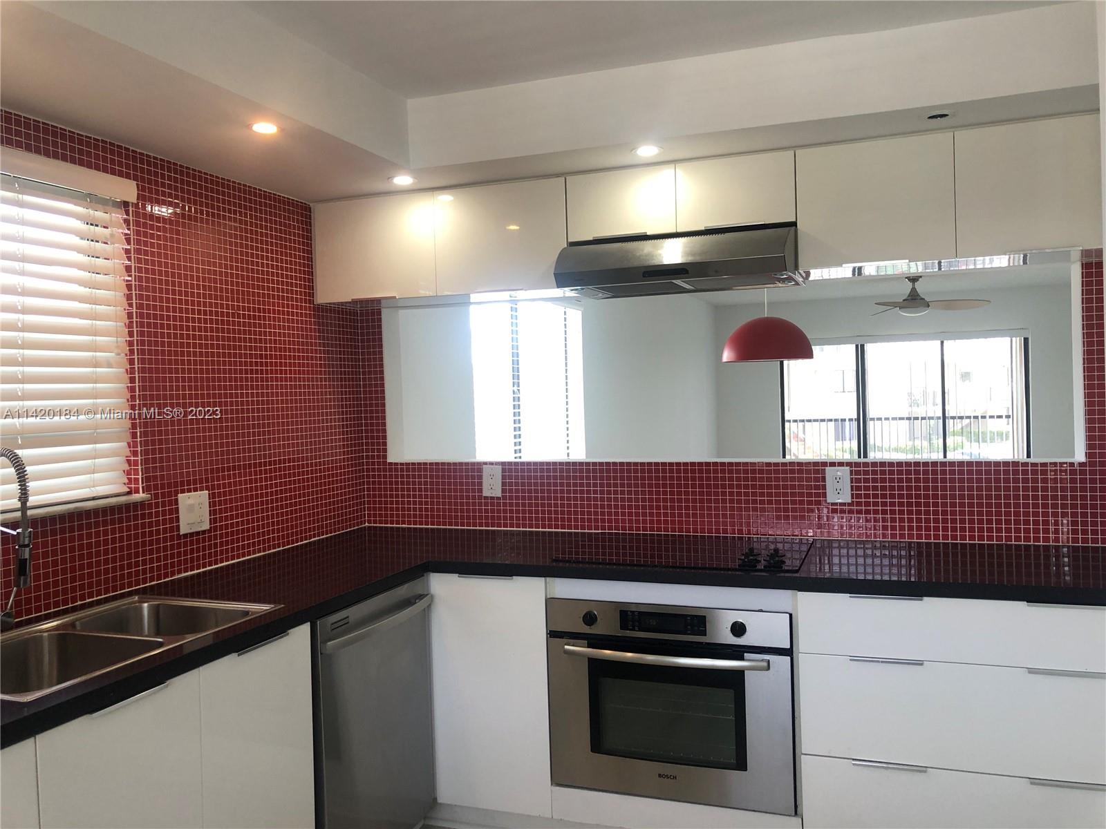 330 Racquet Club Road, Unit 201 Weston, FL 33326 - Photo 14 of 43 a kitchen with a stove and a sink