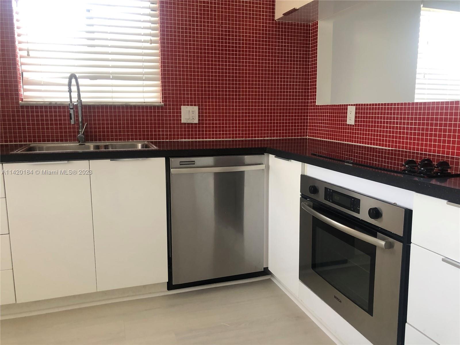330 Racquet Club Road, Unit 201 Weston, FL 33326 - Photo 15 of 43 a kitchen with granite countertop cabinets stainless steel appliances and a window