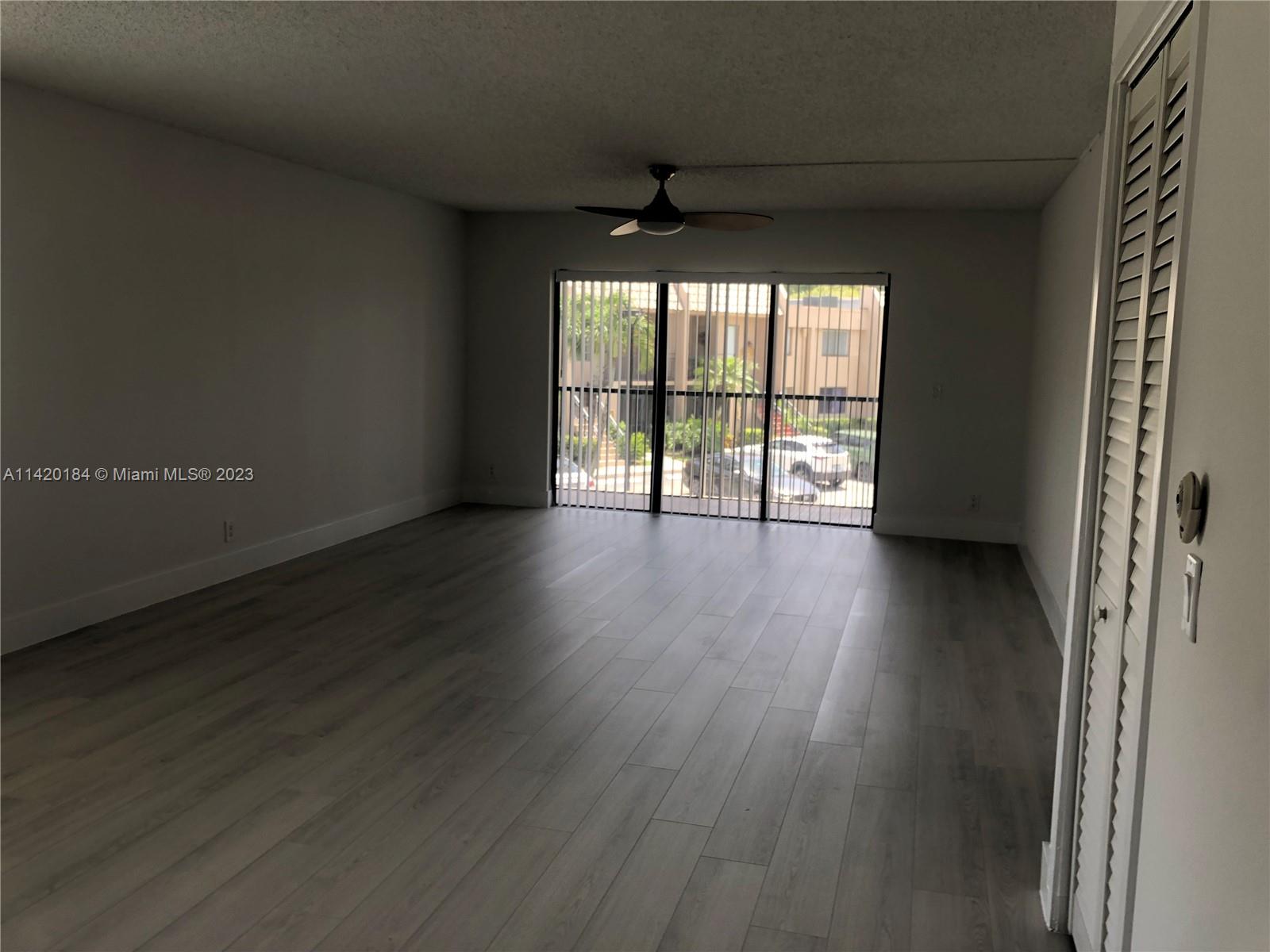 330 Racquet Club Road, Unit 201 Weston, FL 33326 - Photo 18 of 43 a view of an empty room with wooden floor and a window