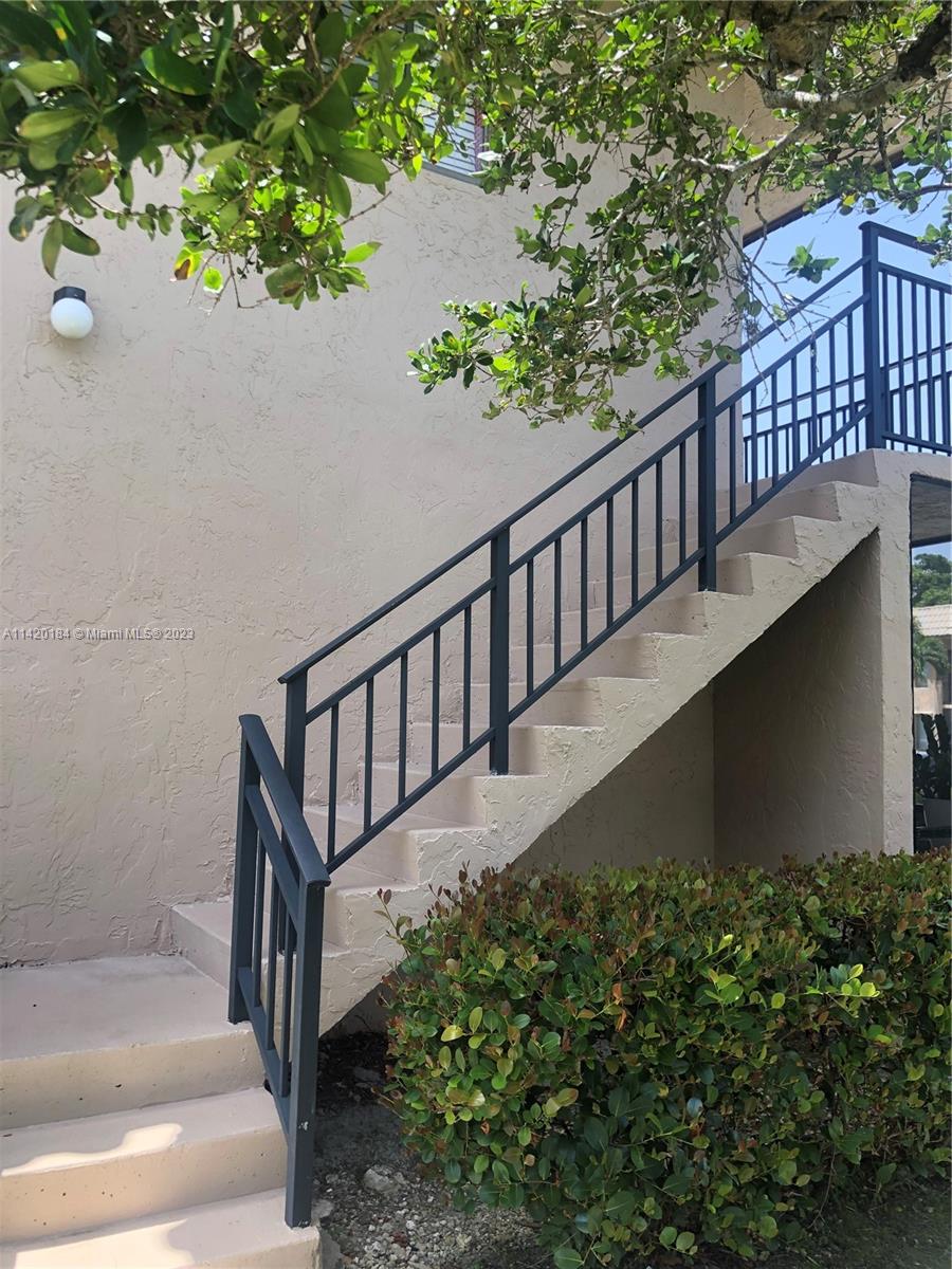 330 Racquet Club Road, Unit 201 Weston, FL 33326 - Photo 3 of 43 a view of a balcony with wooden fence