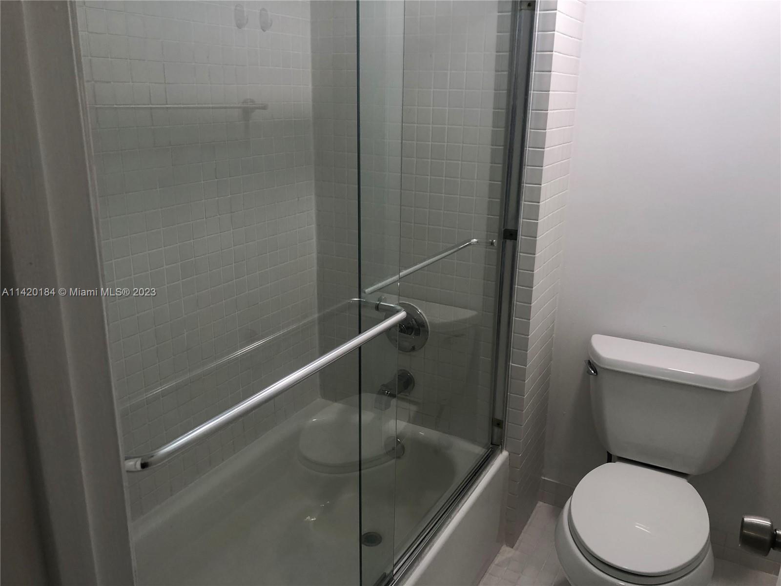 330 Racquet Club Road, Unit 201 Weston, FL 33326 - Photo 31 of 43 a white toilet sitting next to a bath tub