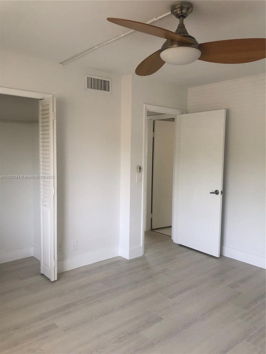 330 Racquet Club Road, Unit 201 Weston, FL 33326 - Photo 33 of 43 a view of an empty room with a ceiling fan
