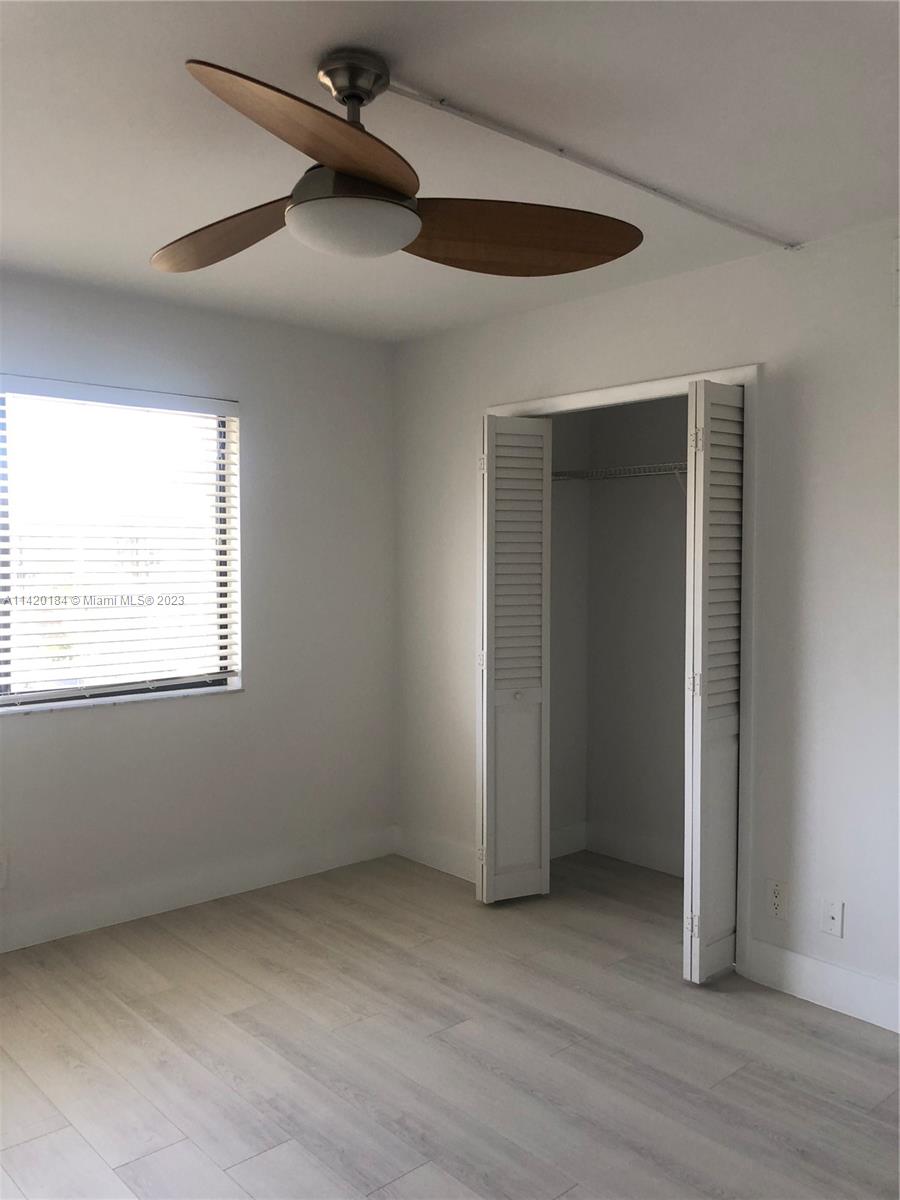 330 Racquet Club Road, Unit 201 Weston, FL 33326 - Photo 34 of 43 an empty room with wooden floor and windows
