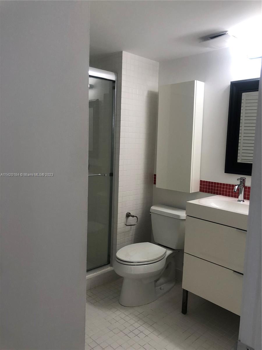 330 Racquet Club Road, Unit 201 Weston, FL 33326 - Photo 35 of 43 a bathroom with a toilet sink and mirror