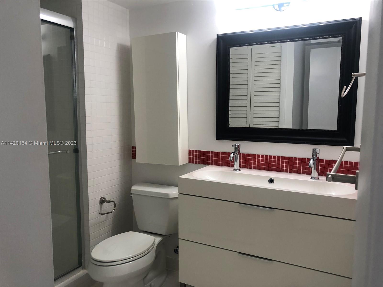 330 Racquet Club Road, Unit 201 Weston, FL 33326 - Photo 36 of 43 a bathroom with a toilet sink and mirror