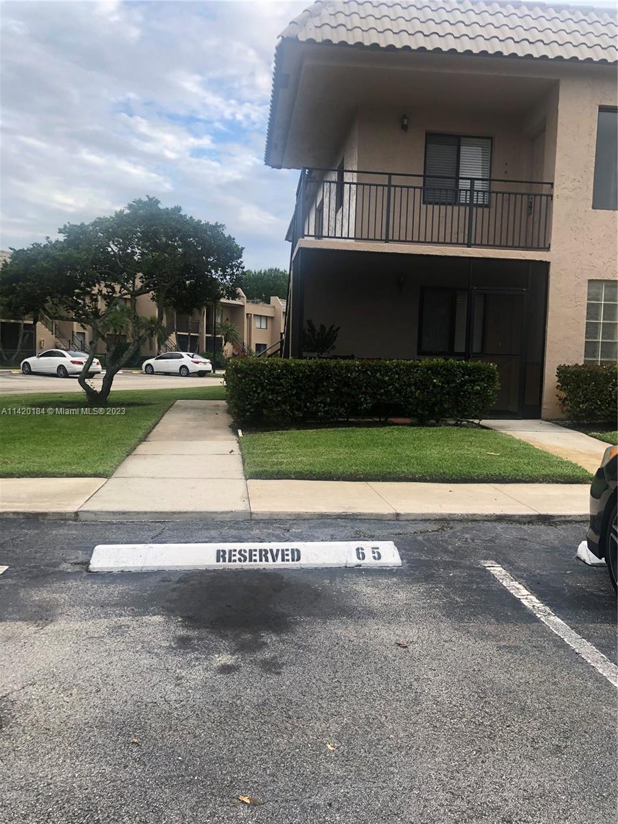 330 Racquet Club Road, Unit 201 Weston, FL 33326 - Photo 41 of 43 a front view of a house with a yard