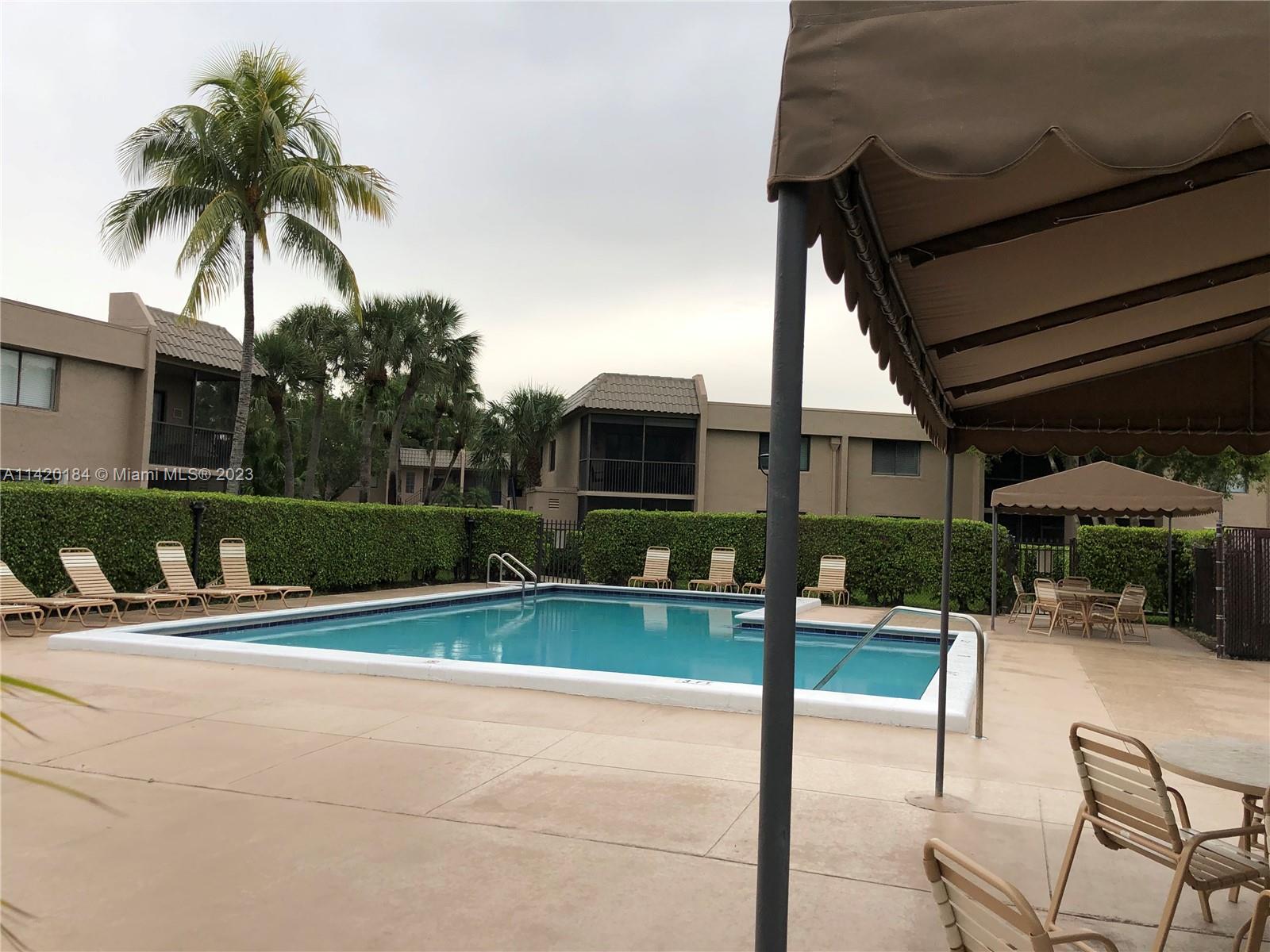 330 Racquet Club Road, Unit 201 Weston, FL 33326 - Photo 42 of 43 a view of a house with backyard and porch