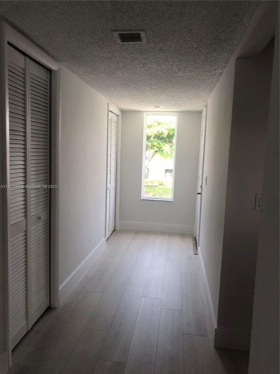 330 Racquet Club Road, Unit 201 Weston, FL 33326 - Photo 7 of 43 an empty room with wooden floor and a window