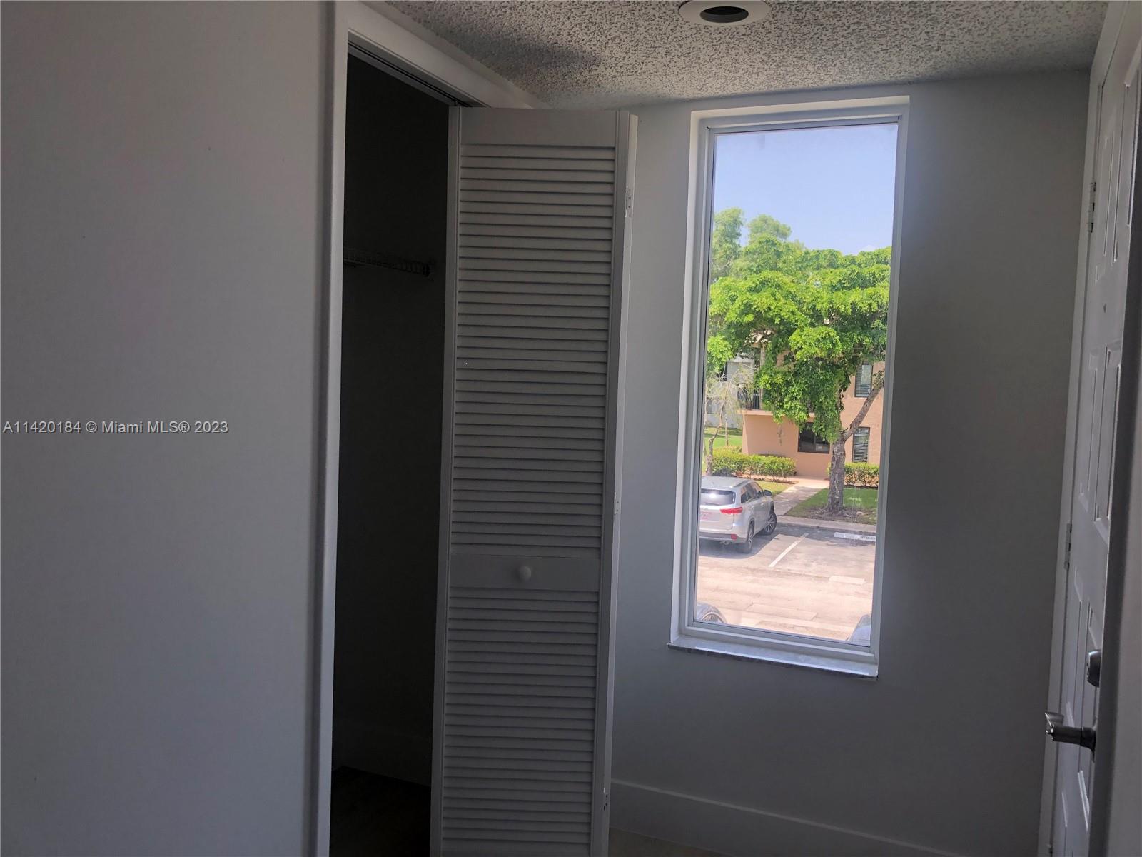 330 Racquet Club Road, Unit 201 Weston, FL 33326 - Photo 8 of 43 a view of a glass door and a window