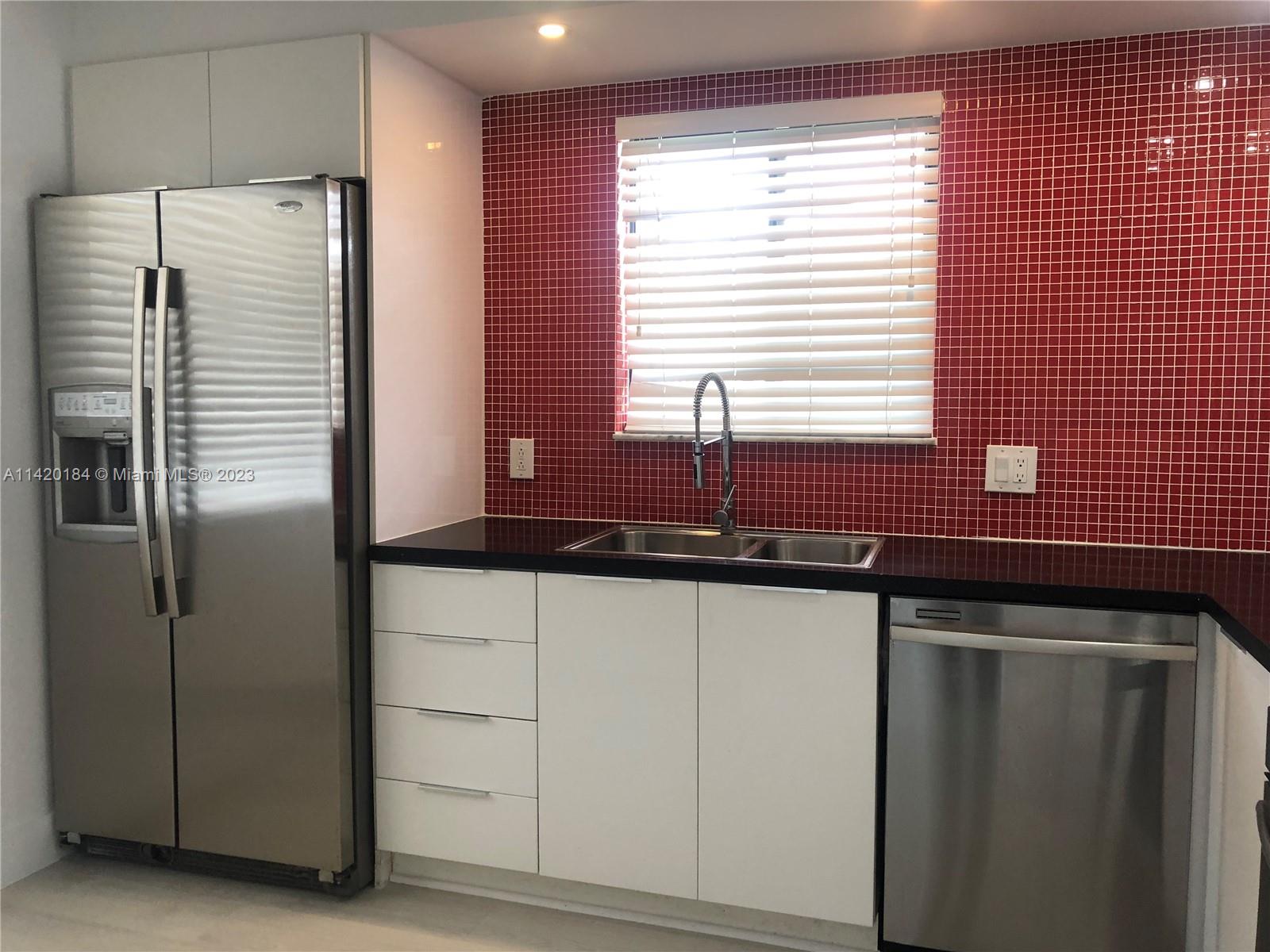 330 Racquet Club Road, Unit 201 Weston, FL 33326 - Photo 9 of 43 a kitchen with stainless steel appliances granite countertop a refrigerator and a sink