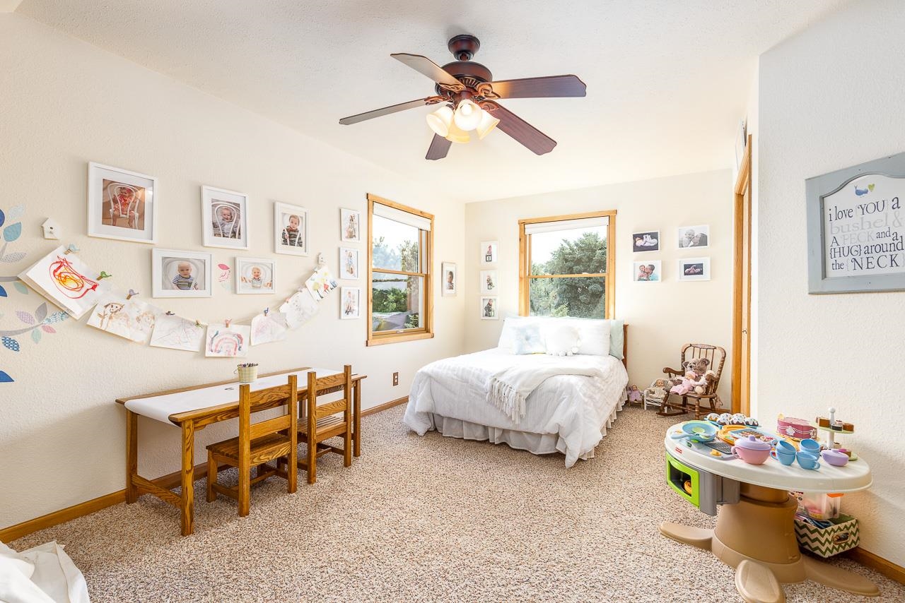 6287 South Perryville Road Cherry Valley, IL 61016 - Photo 16 of 38 a spacious bedroom with a bed and a table