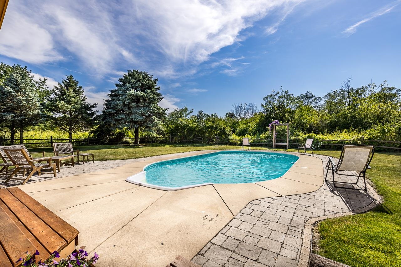 6287 South Perryville Road Cherry Valley, IL 61016 - Photo 28 of 38 a view of a swimming pool with a patio