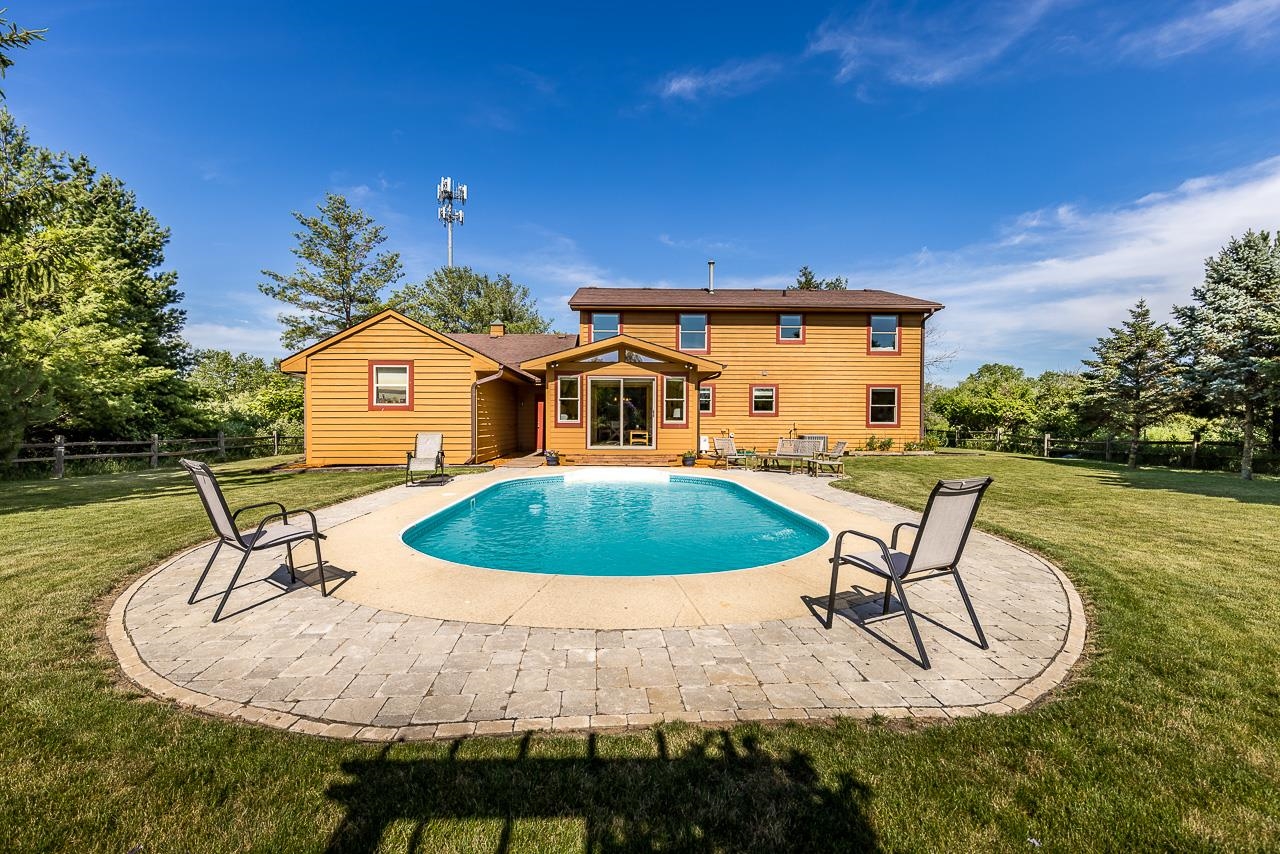 6287 South Perryville Road Cherry Valley, IL 61016 - Photo 32 of 38 a house view with a swimming pool and outdoor space