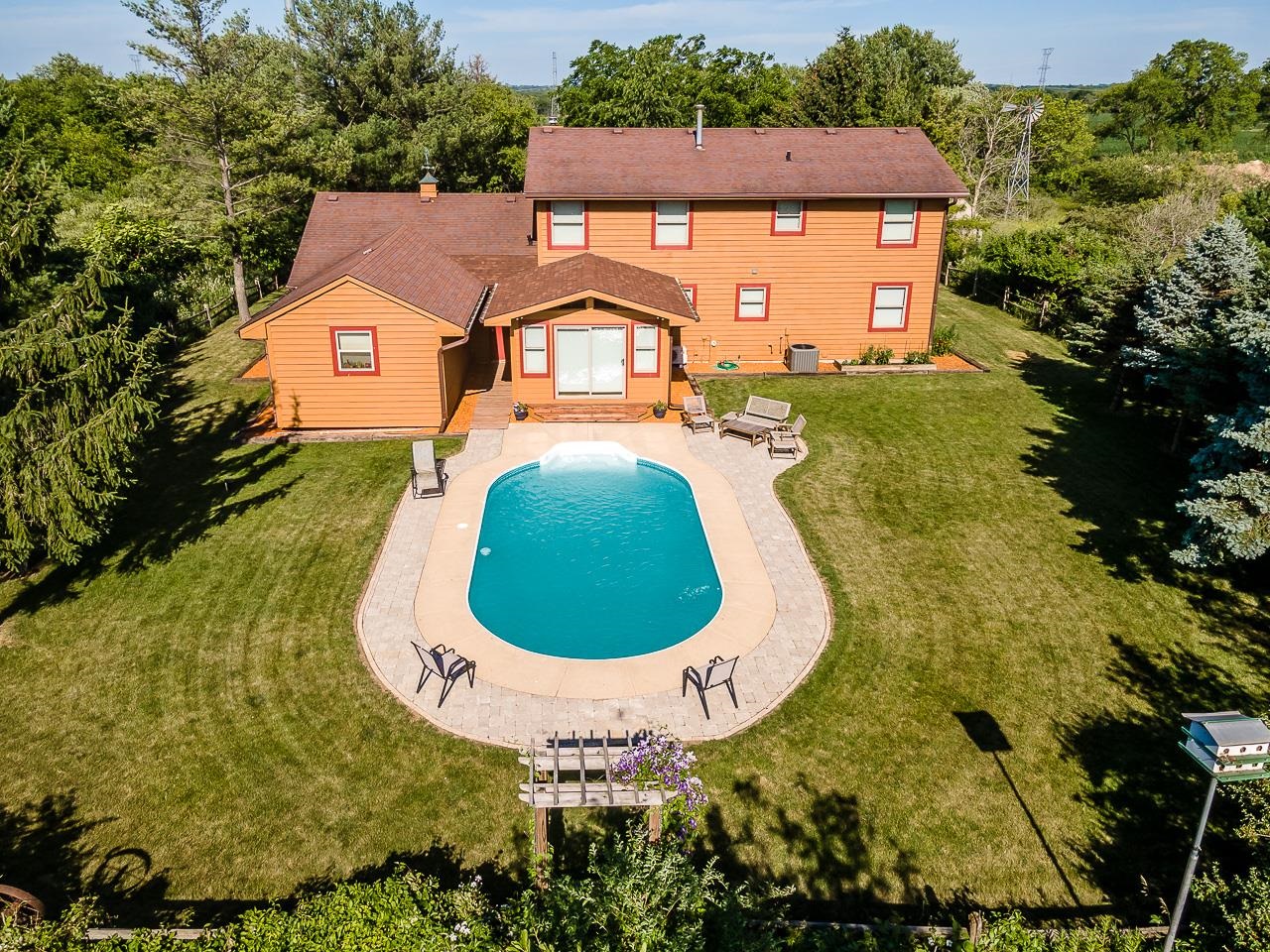 6287 South Perryville Road Cherry Valley, IL 61016 - Photo 34 of 38 an aerial view of a house with swimming pool and green space