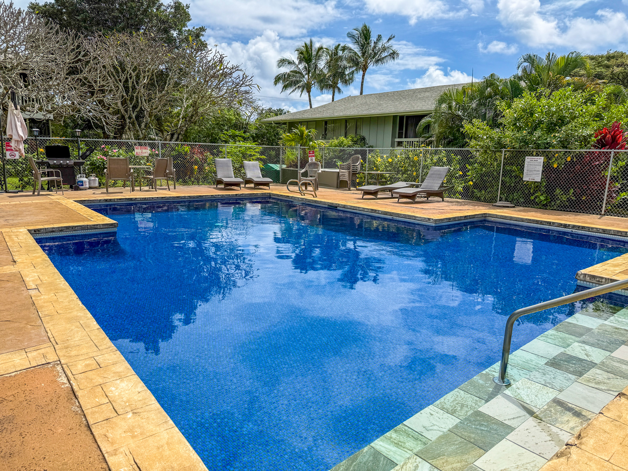 3057 Poipu Road, Unit D13 Koloa, HI 96756 - Photo 17 of 18 a swimming pool with outdoor seating