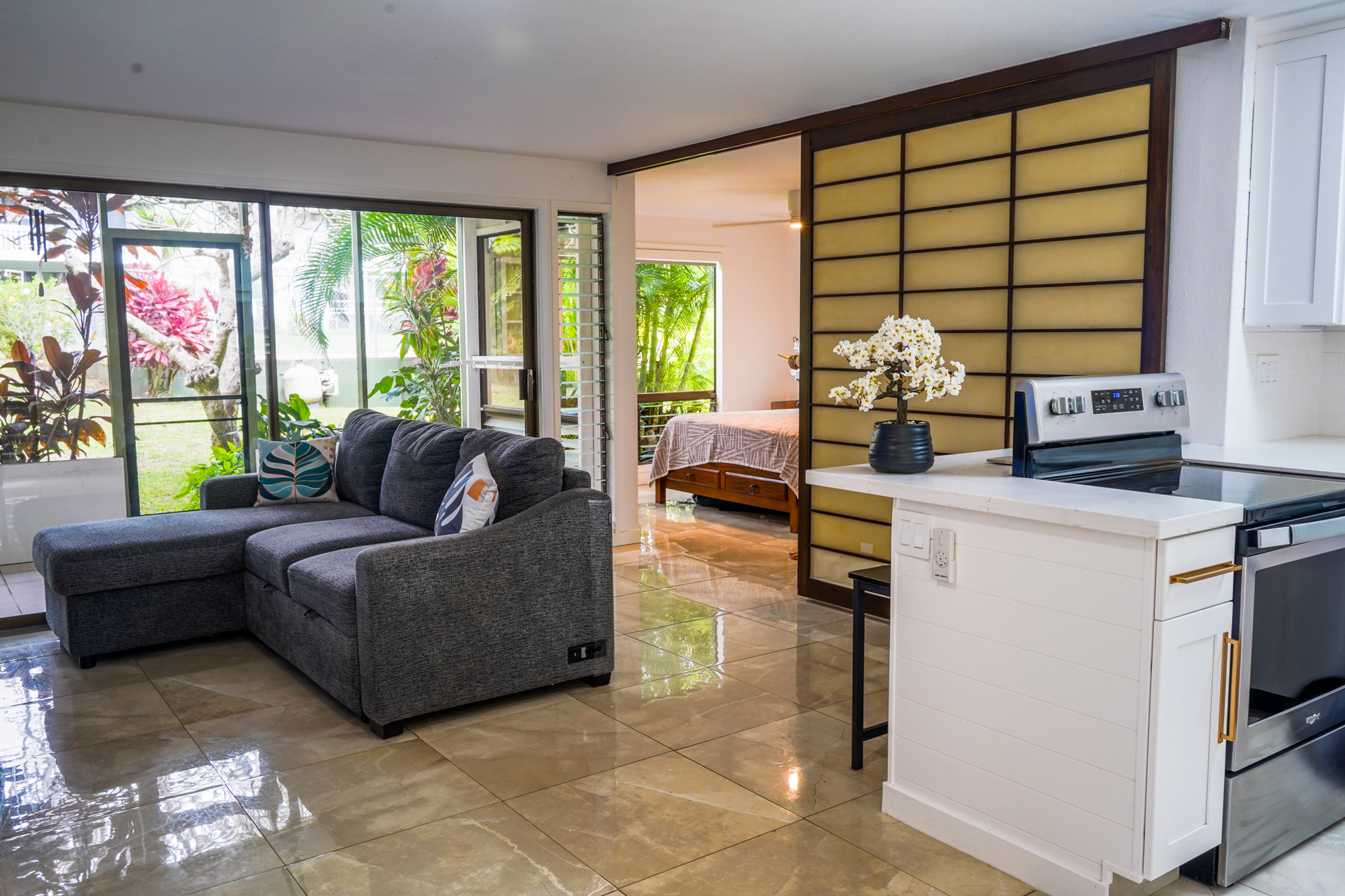 3057 Poipu Road, Unit D13 Koloa, HI 96756 - Photo 2 of 18 a living room with furniture and large windows