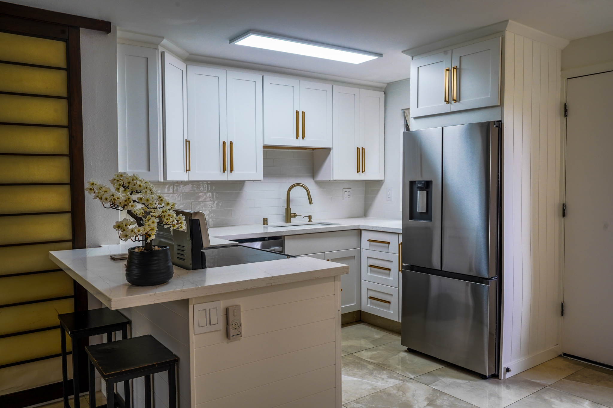 3057 Poipu Road, Unit D13 Koloa, HI 96756 - Photo 3 of 18 a kitchen with stainless steel appliances a refrigerator sink and cabinets