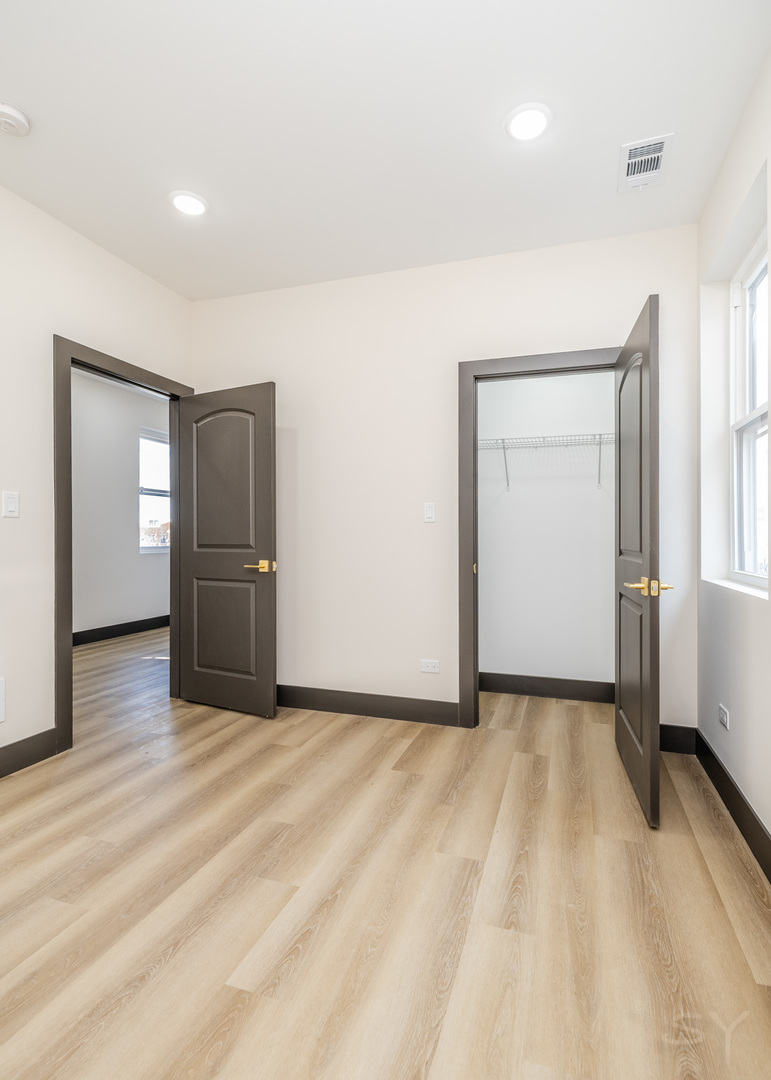 5643 South Prairie Avenue, Unit 1 Chicago, IL 60637 - Photo 10 of 15 a view of empty room with wooden floor and cabinet