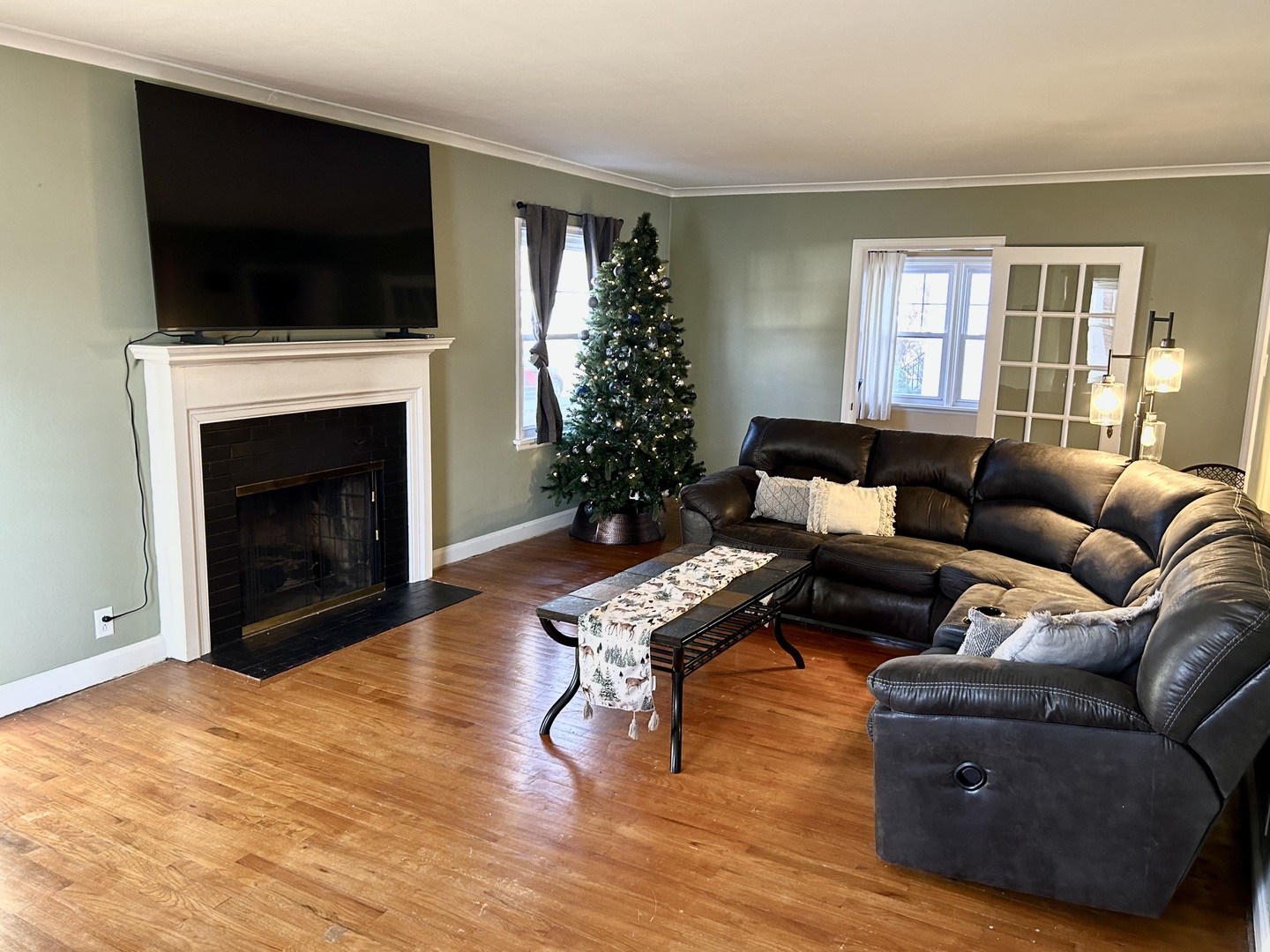 428 East Thompson Street Princeton, IL 61356 - Photo 2 of 22 a living room with furniture a flat screen tv and a fireplace