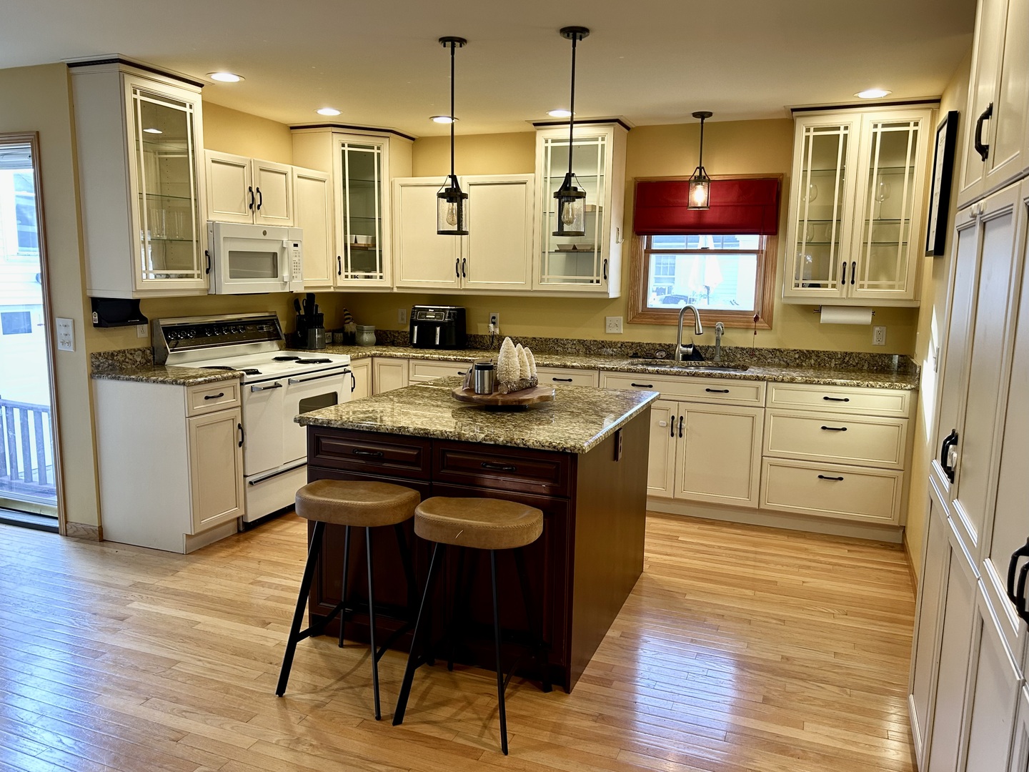 428 East Thompson Street Princeton, IL 61356 - Photo 4 of 22 a kitchen with stainless steel appliances granite countertop a stove a sink dishwasher a refrigerator white cabinets with wooden floor