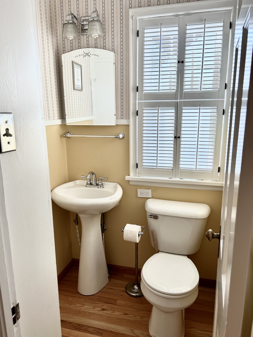 428 East Thompson Street Princeton, IL 61356 - Photo 7 of 22 a bathroom with a toilet sink and mirror